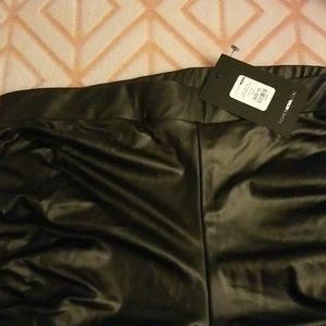 Black faux leather stacked pants